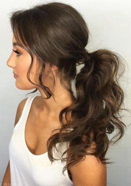 Wavy hair low ponytail hairstyles for women with long bangs